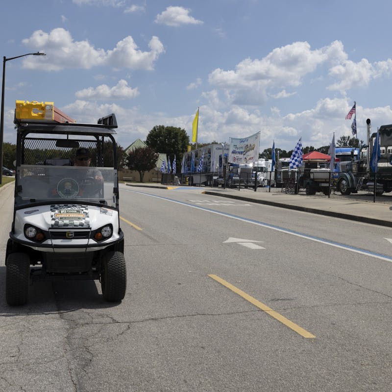 THOR's mobile RV repair service golf cart driving down the road at the Atlanta Motor Speedway