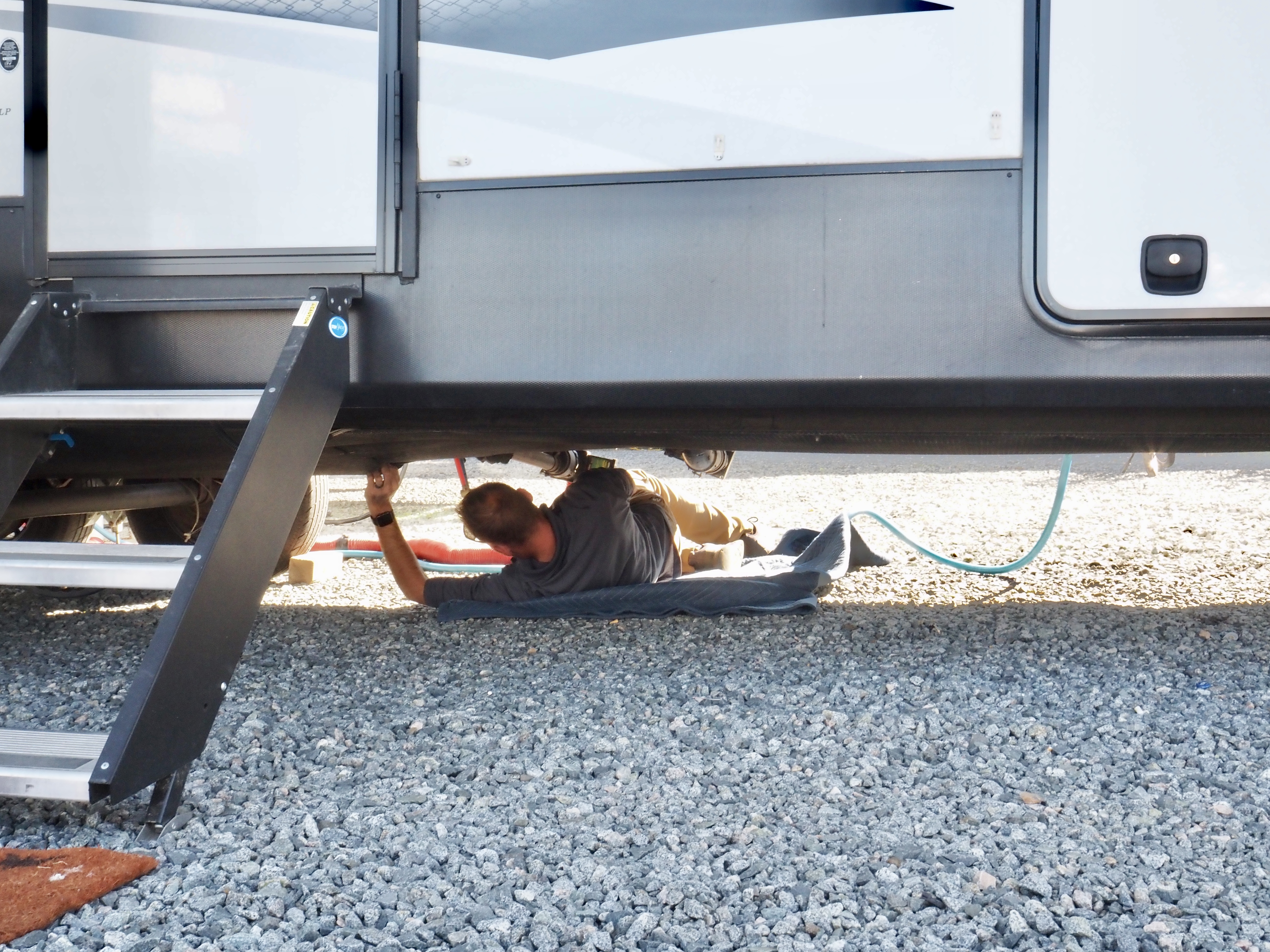 A THOR mobile RV repair technician working on Bailey and Nicole Damberg's RV