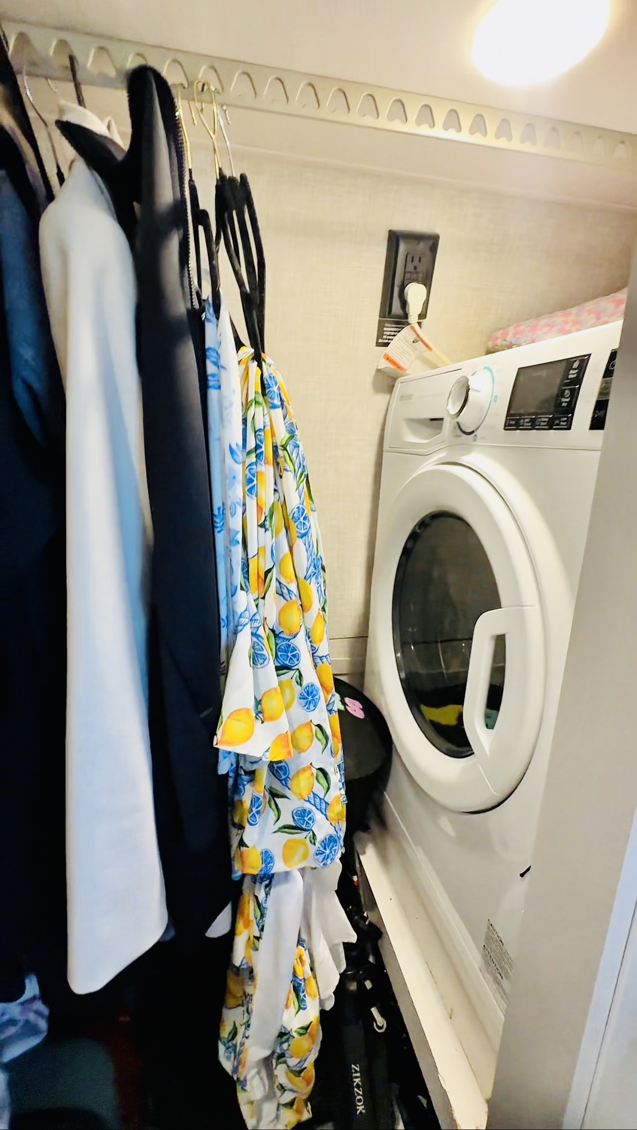 A vented washer-dryer combo inside an RV closet 
