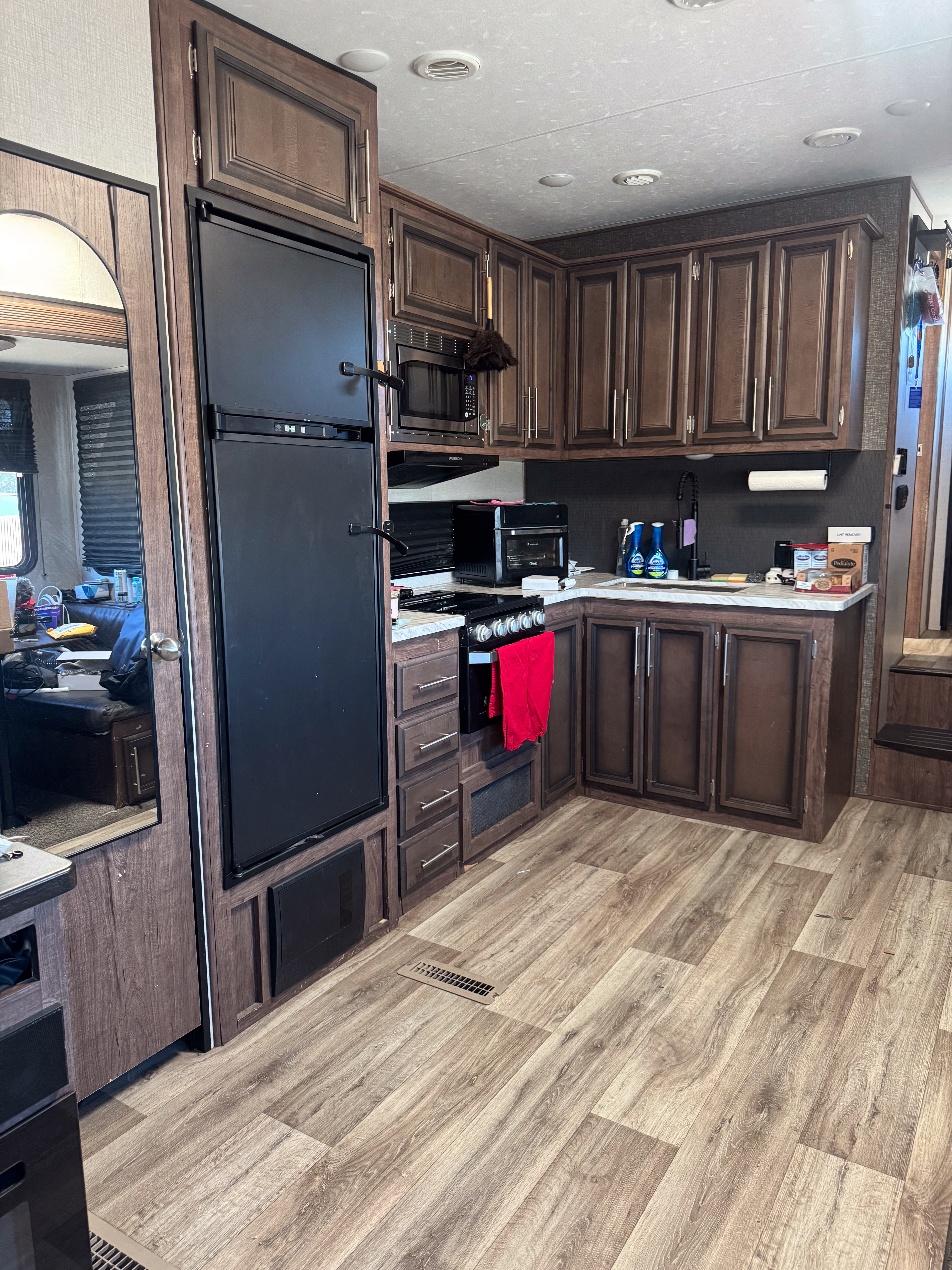 An RV kitchen with a ninja airfryer and tea station on the counter 