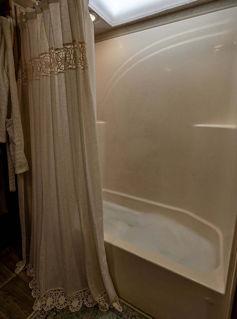 The tub inside of a toy hauler RV filled as a bubble bath