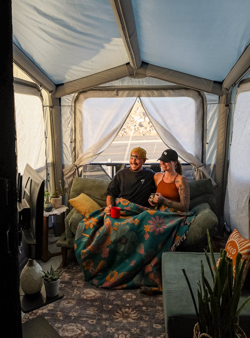 Kearstin and David Saul in their enclosed porch tent off their toy hauler patio