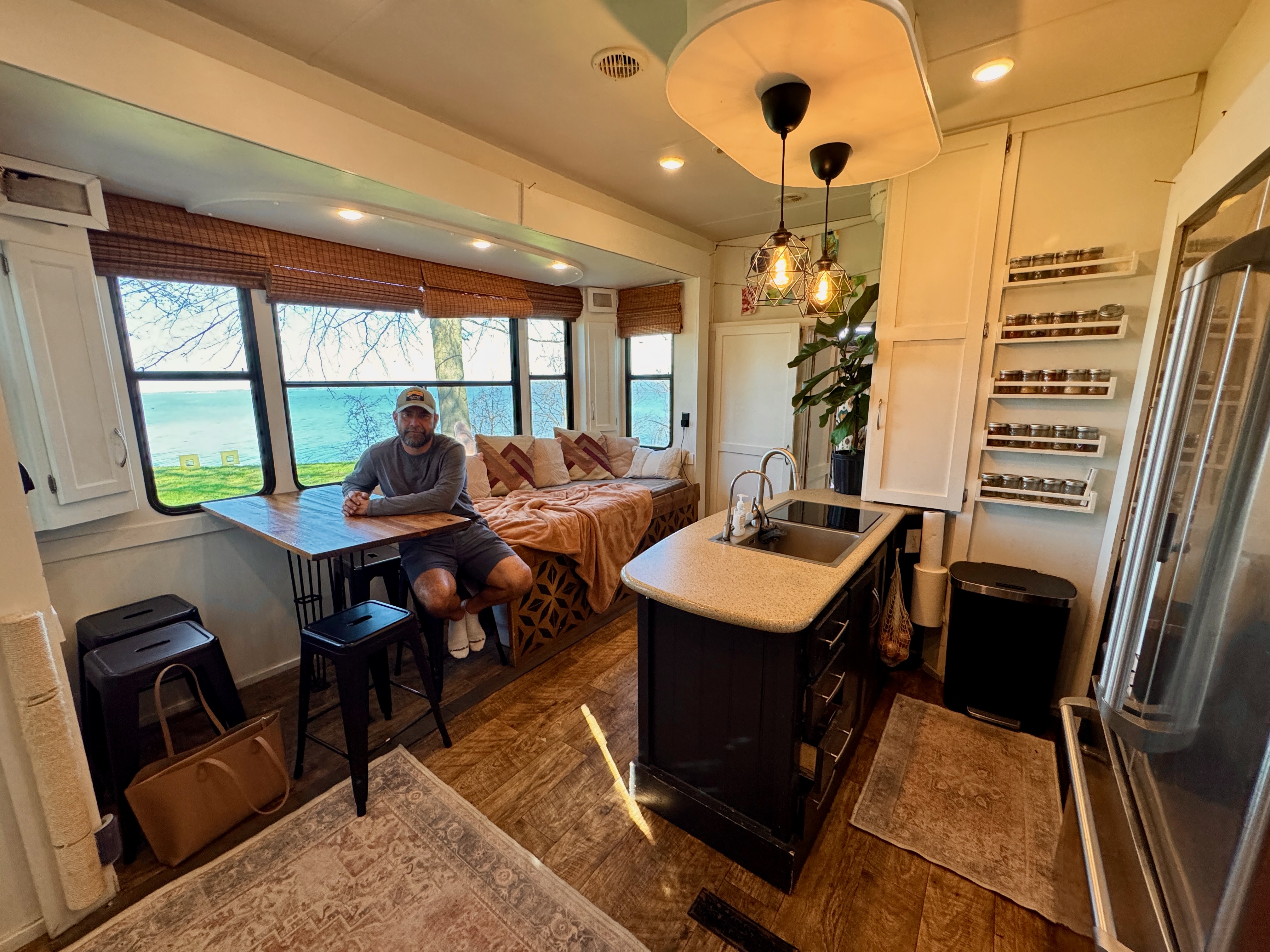 Lucas Lahr sits at the dinnette inside his heartland torque toy hauler 