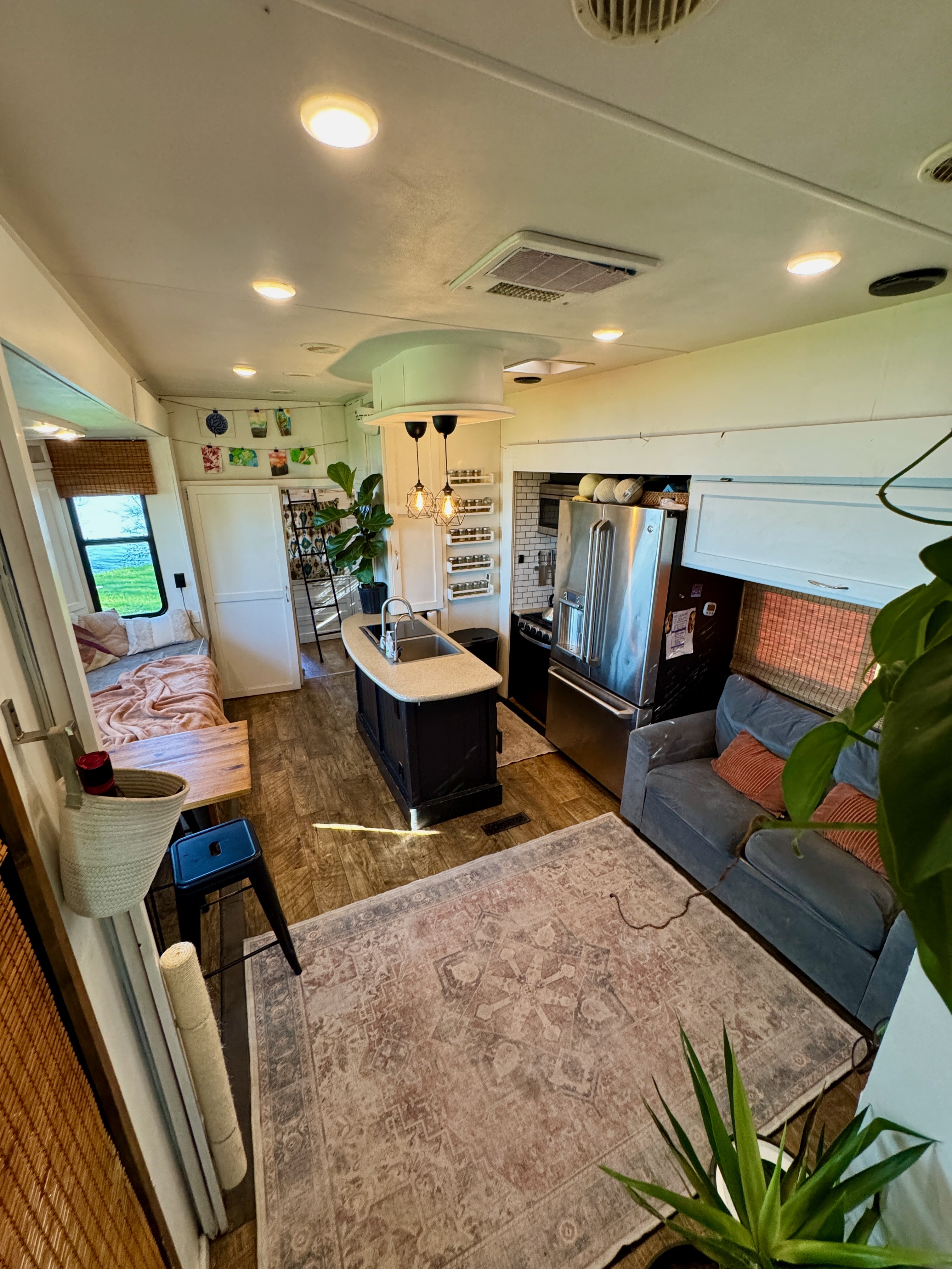 The kitchen and living area of Melissa Lahr's Heartland Torque with cozy rugs and homey finishes