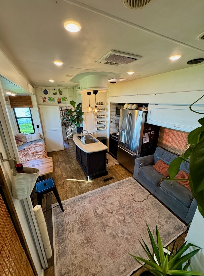 The kitchen and living area of Melissa Lahr's Heartland Torque with cozy rugs and homey finishes