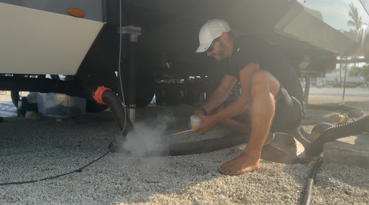 Josh Bailey sprinkling diatomaceous earth around the RV 