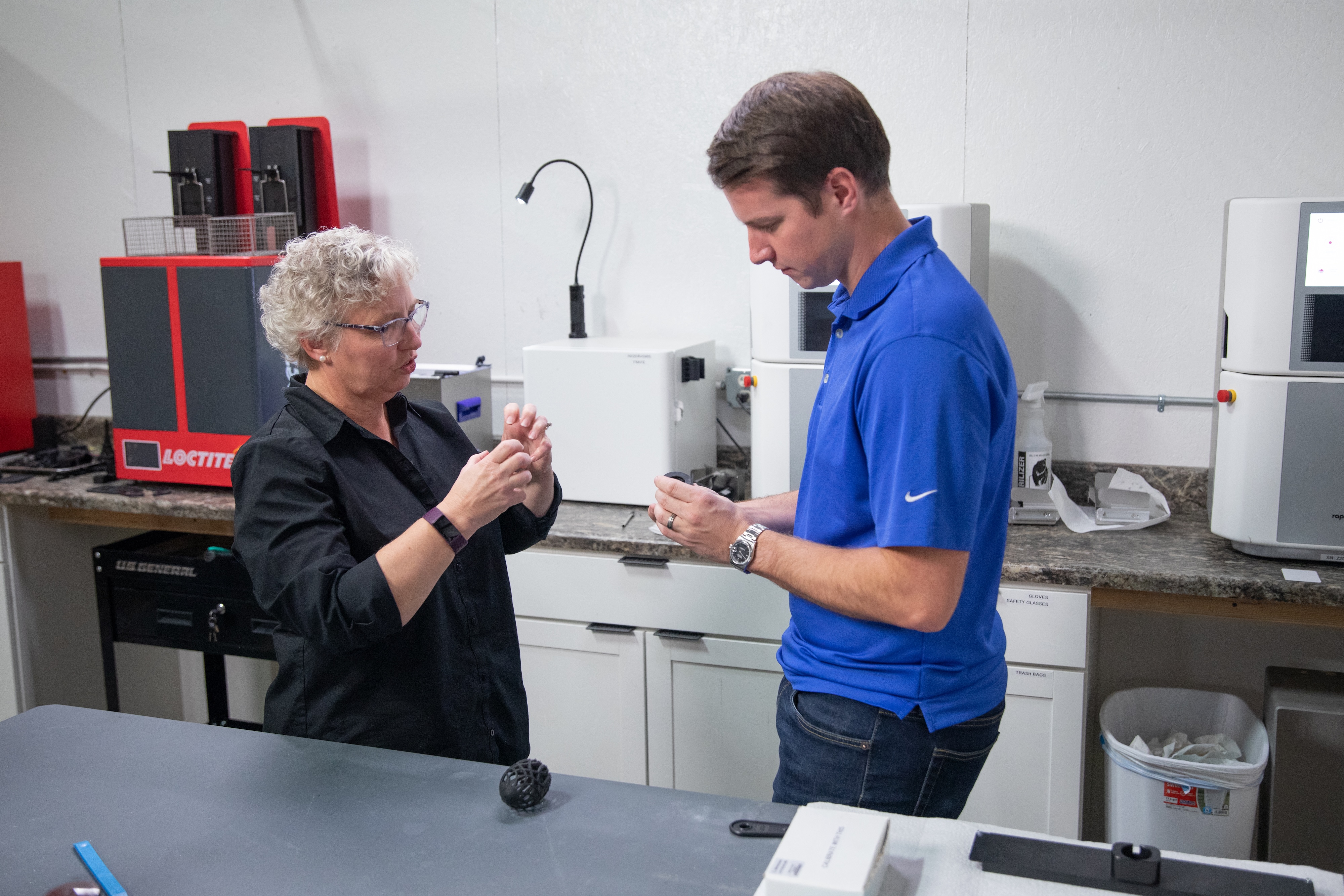 A man and a woman looking an RV part in an innovation lab 