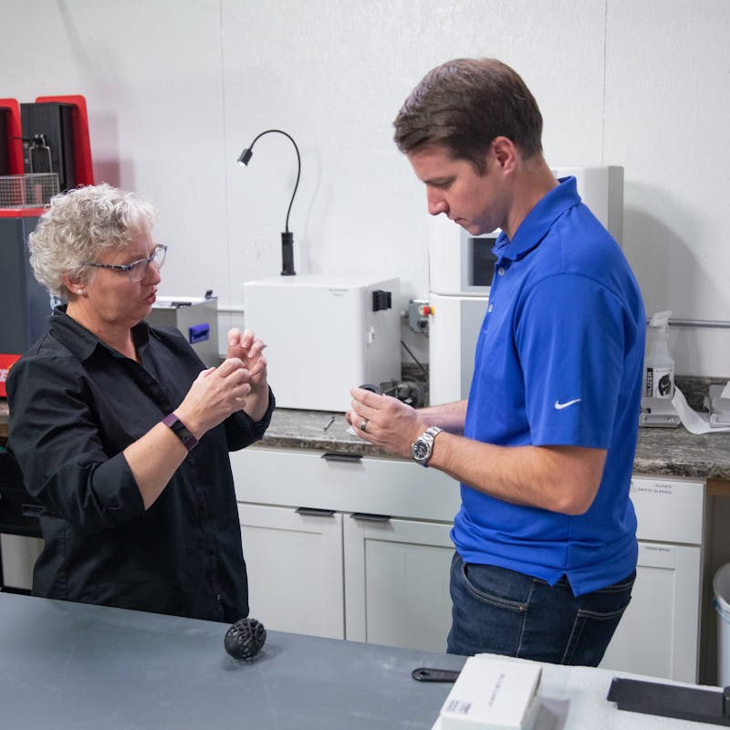 A man and a woman looking an RV part in an innovation lab