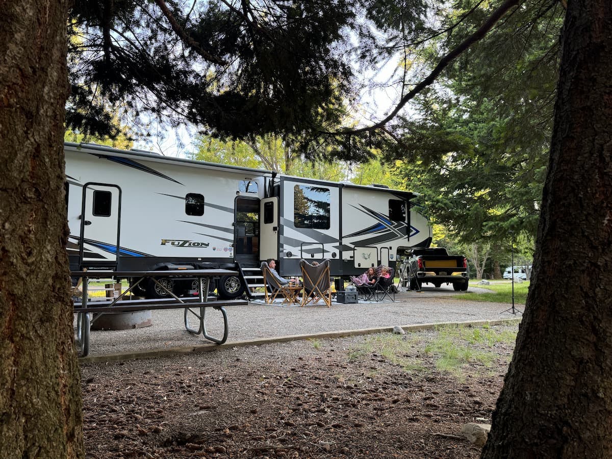 Ashley Peeples enjoying a campfire outside of their Keystone Fuzion toy hauler.