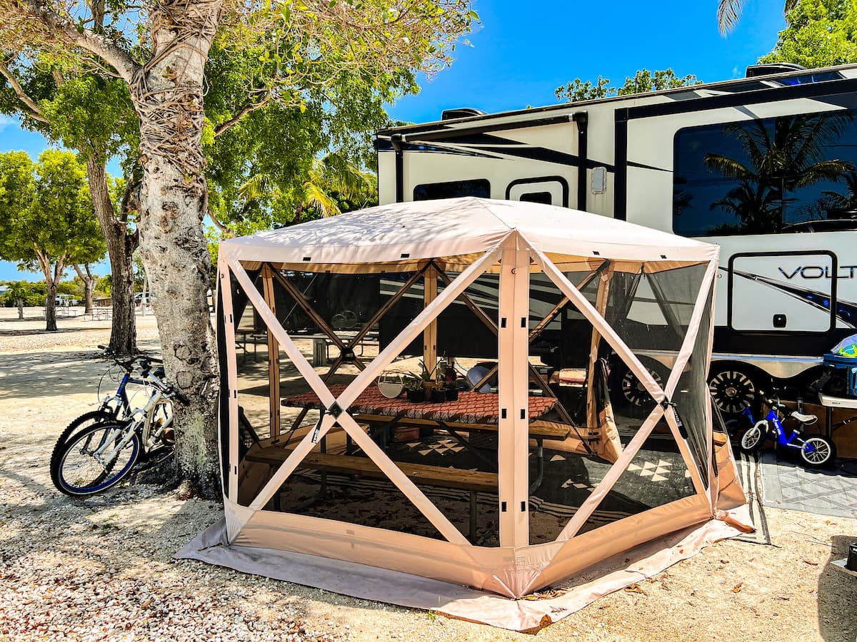 Samantha Edmunds shows a tent covering a picnic table at a campsite