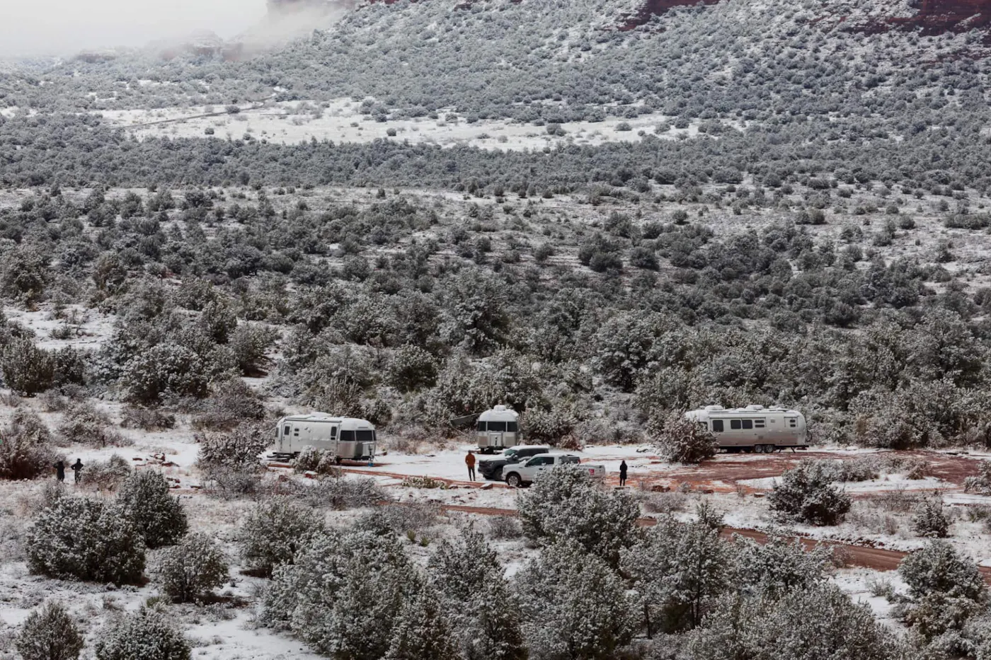 Karen Blue's Airstream camping with other Airstreamers in a snowy desert.