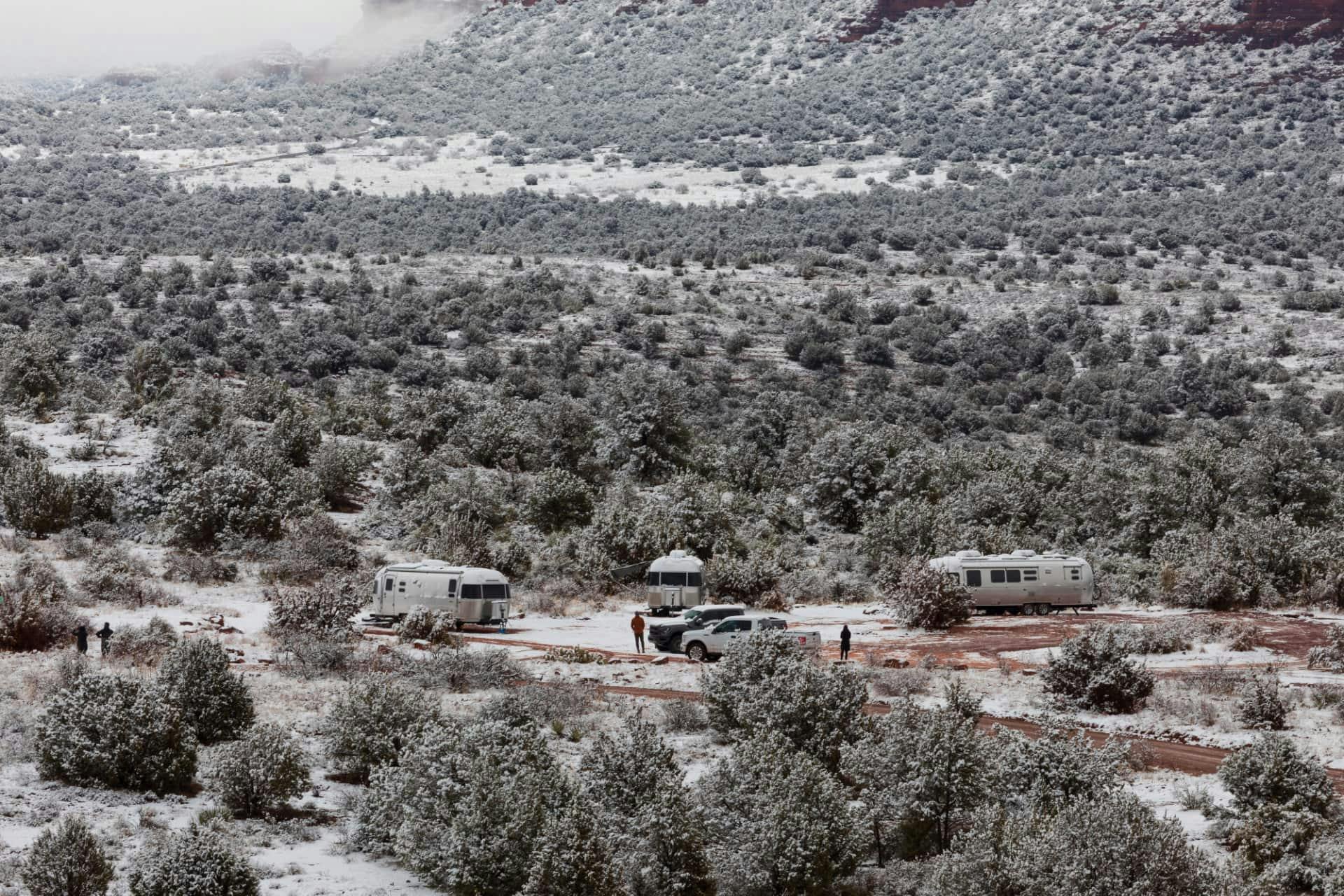 Karen Blue's Airstream camping with other Airstreamers in a snowy desert.