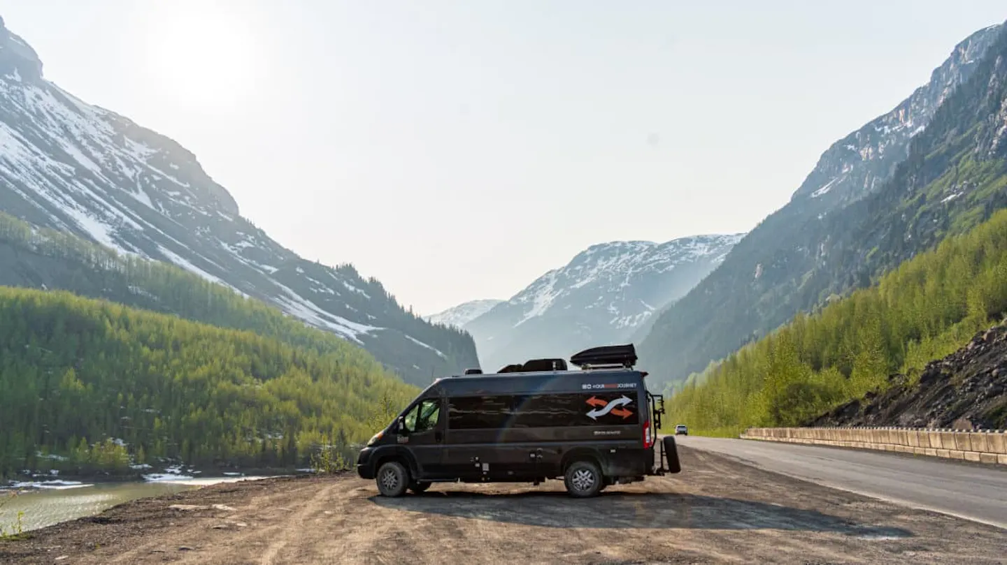 Gabe and Rocio Rivero's campervan parked in front of a beautiful mountain valley.