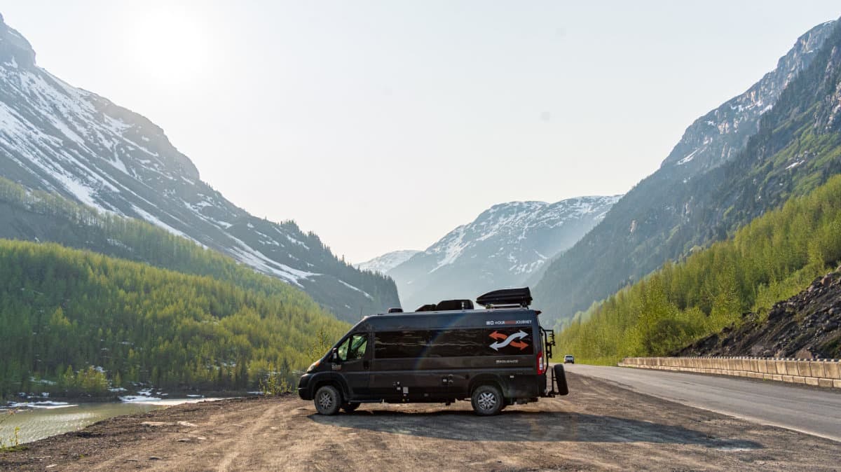 Gabe and Rocio Rivero's campervan parked in front of a beautiful mountain valley.