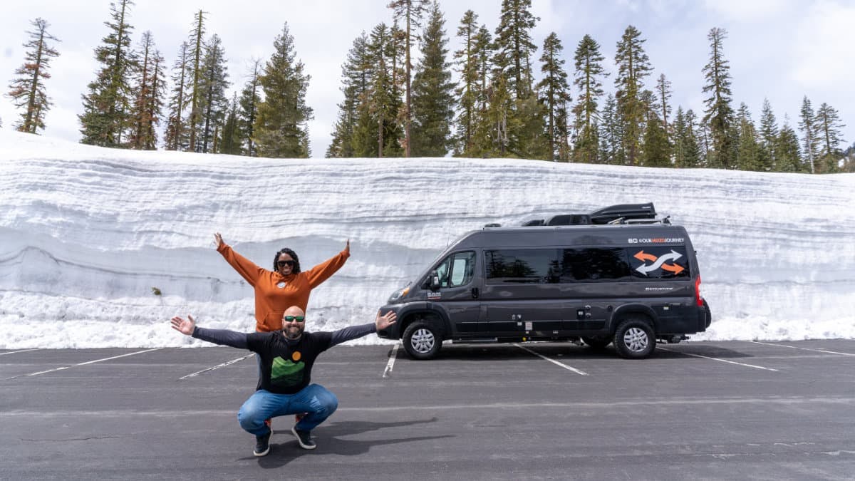 Gabe and Rocio Rivero posing for a picture in front of a snowy road.