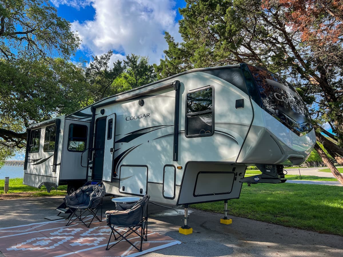 Donny and Tammy Benedict's Keystone Cougar travel trailer at a campsite.