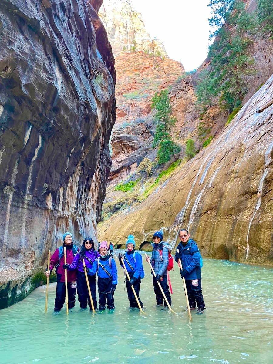 BRENDA & TIGER's group RV trip gathered for a photo on a hike through the Narrows in Zion national park.