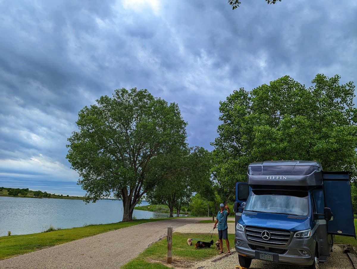 Dustin and Sarah Bauer's RV parked at a campsite next to a lake.