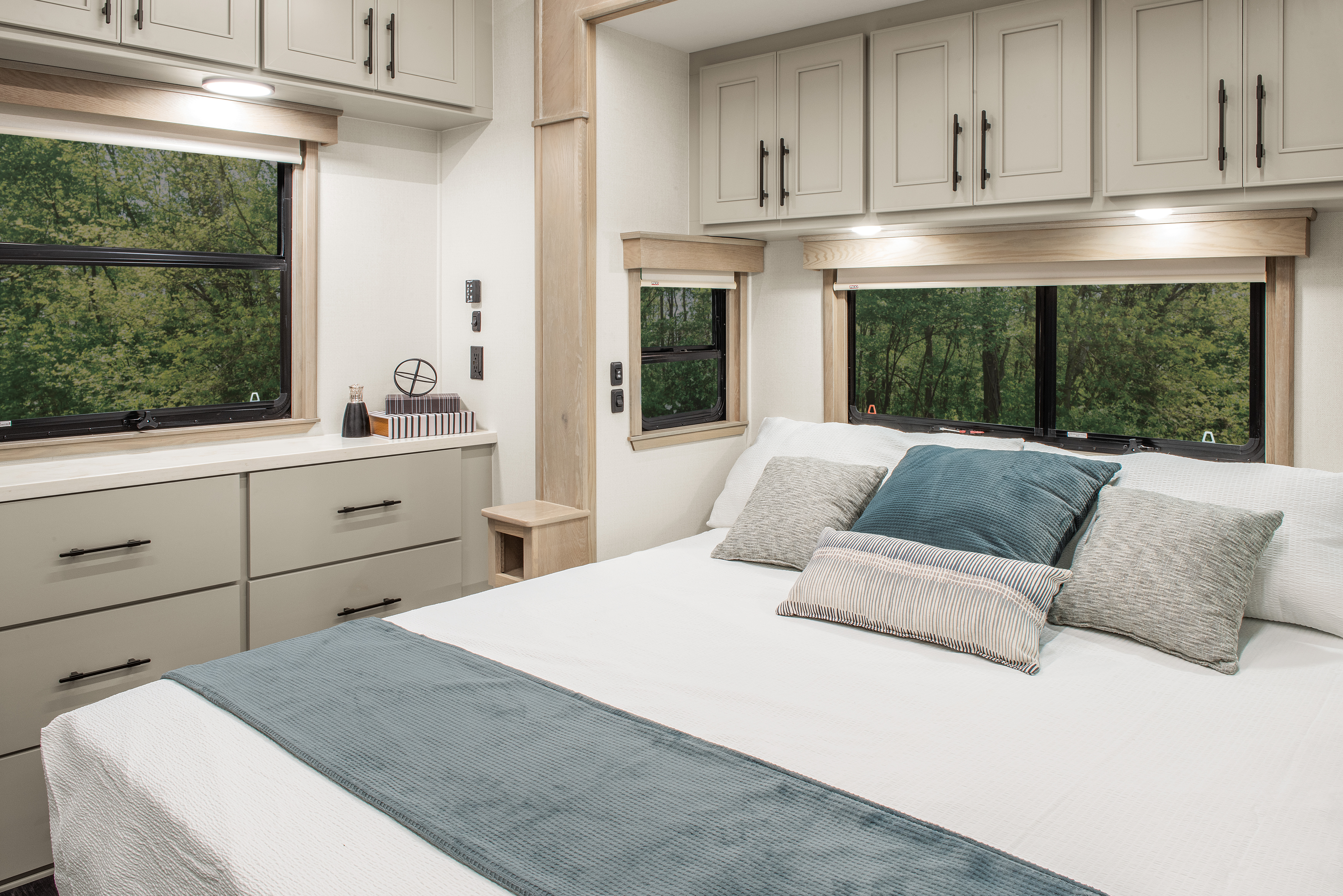 A large, clean bedroom in a DRV mobile Suites RV