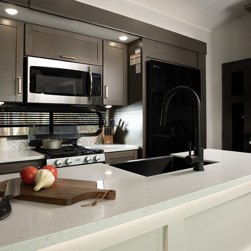 The kitchen island and residential appliances inside of a heartland milestone fifth wheel