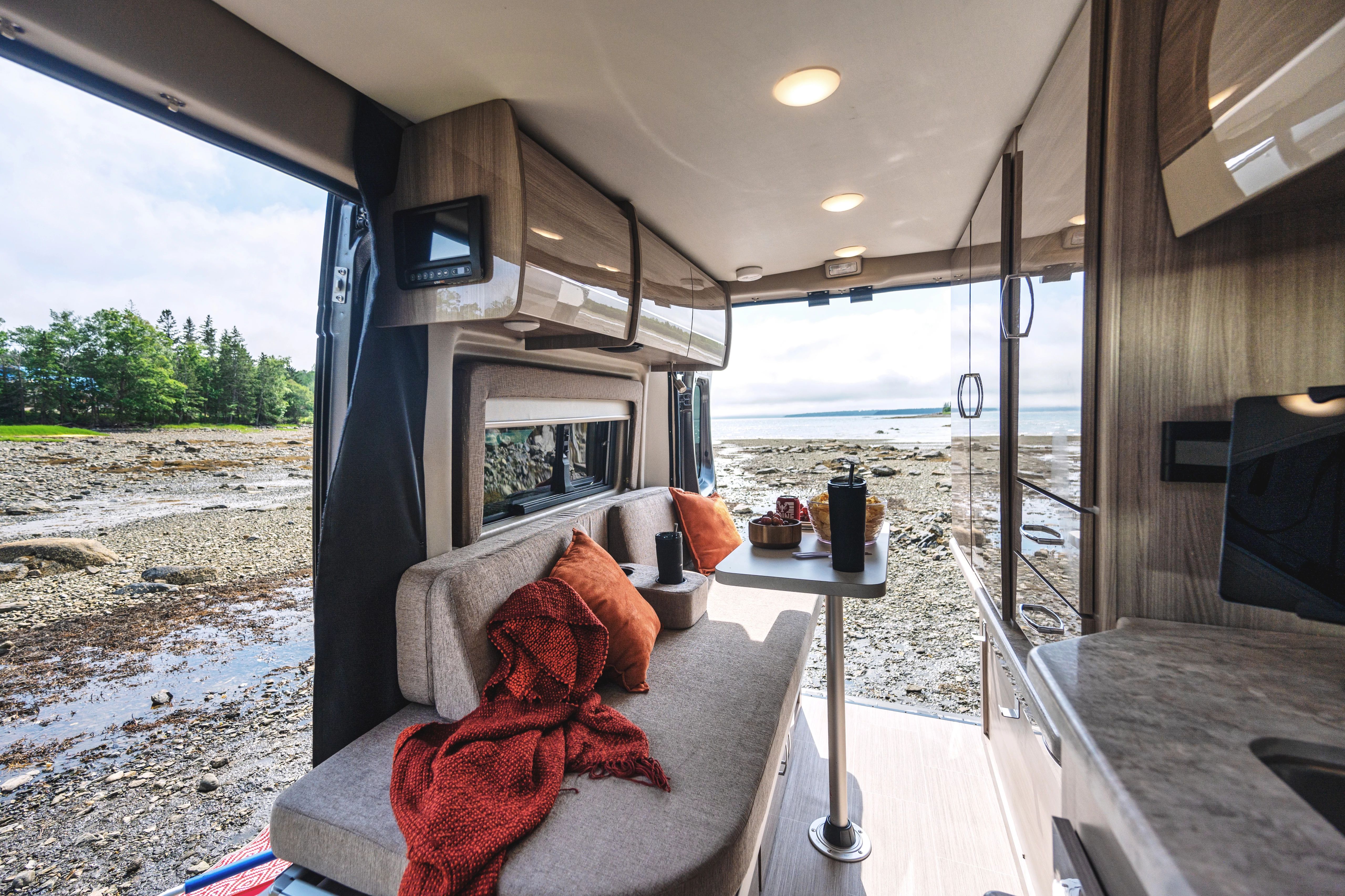 The living room and dinette of a Thor Motor Coach Scope Camper Van