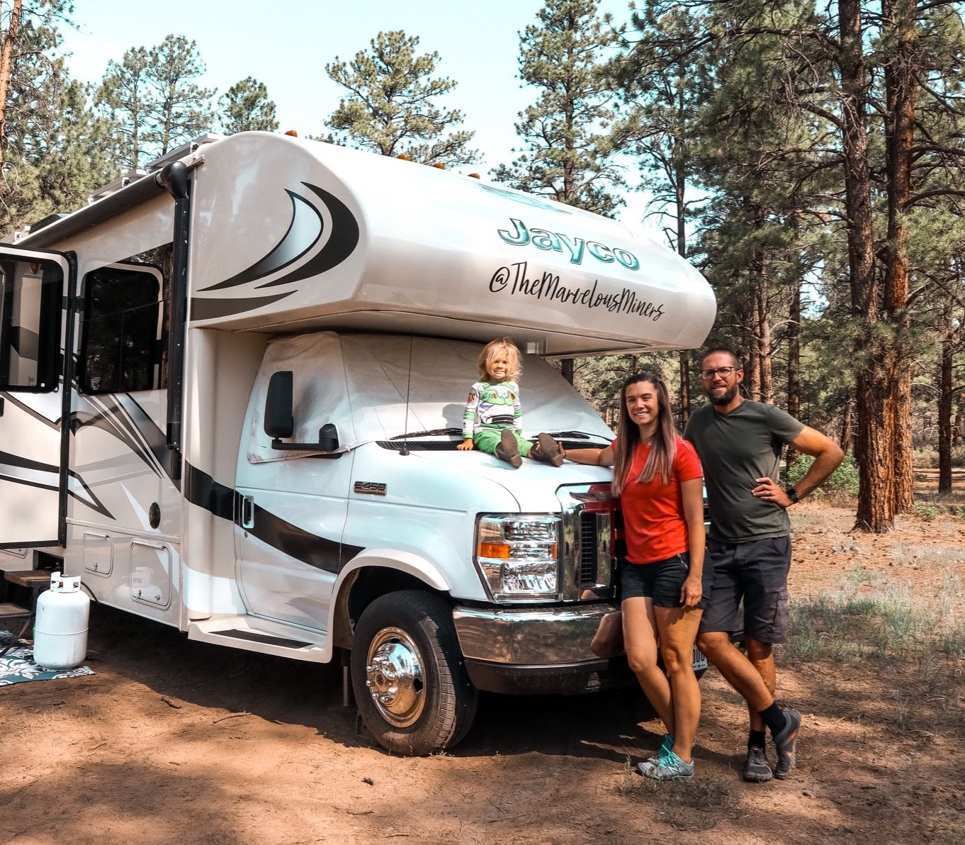 Holly Miner and her family pose for a picture in front of their Jayco Greyhawk