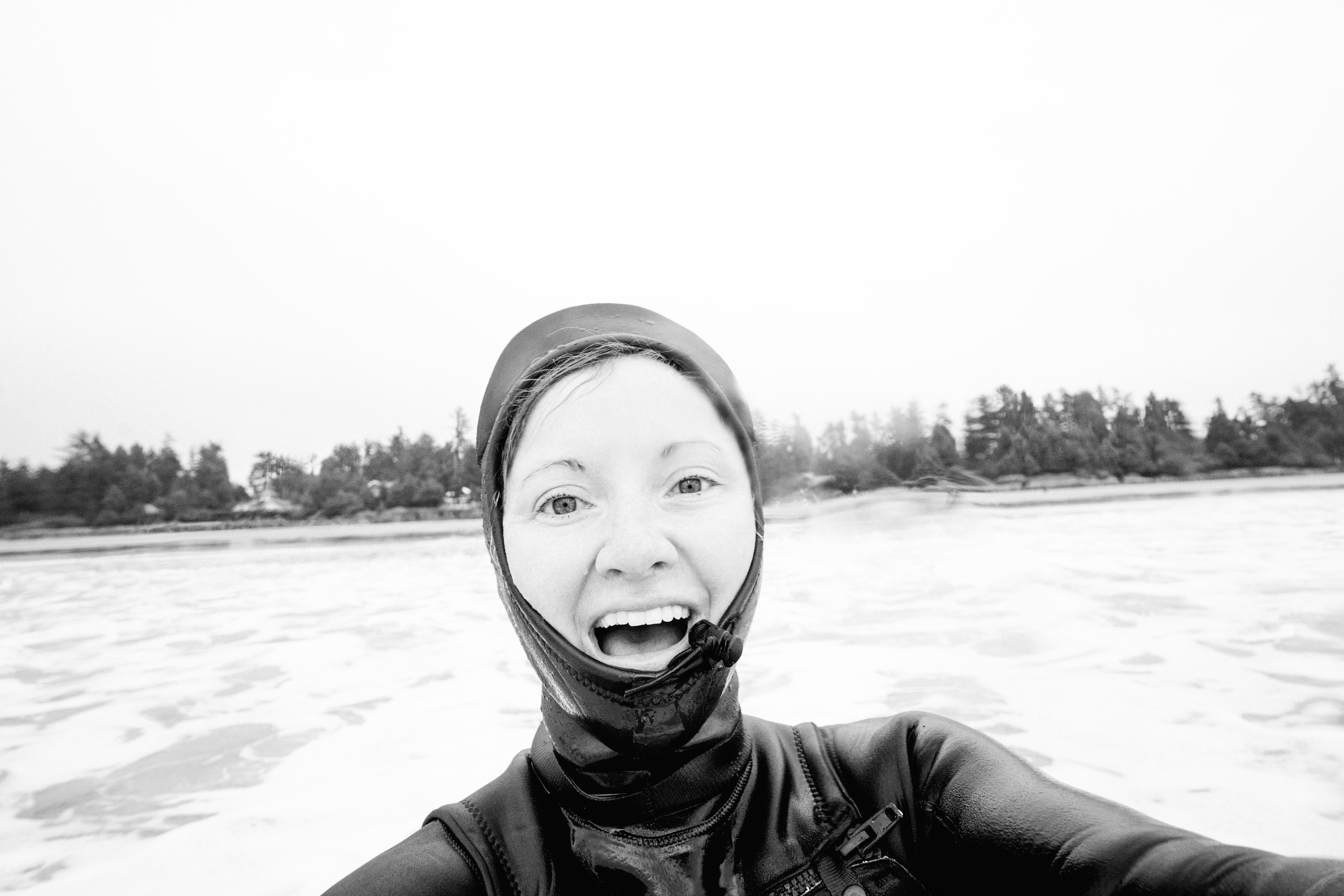 Stacey Powers takes a selfie while surfboarding 