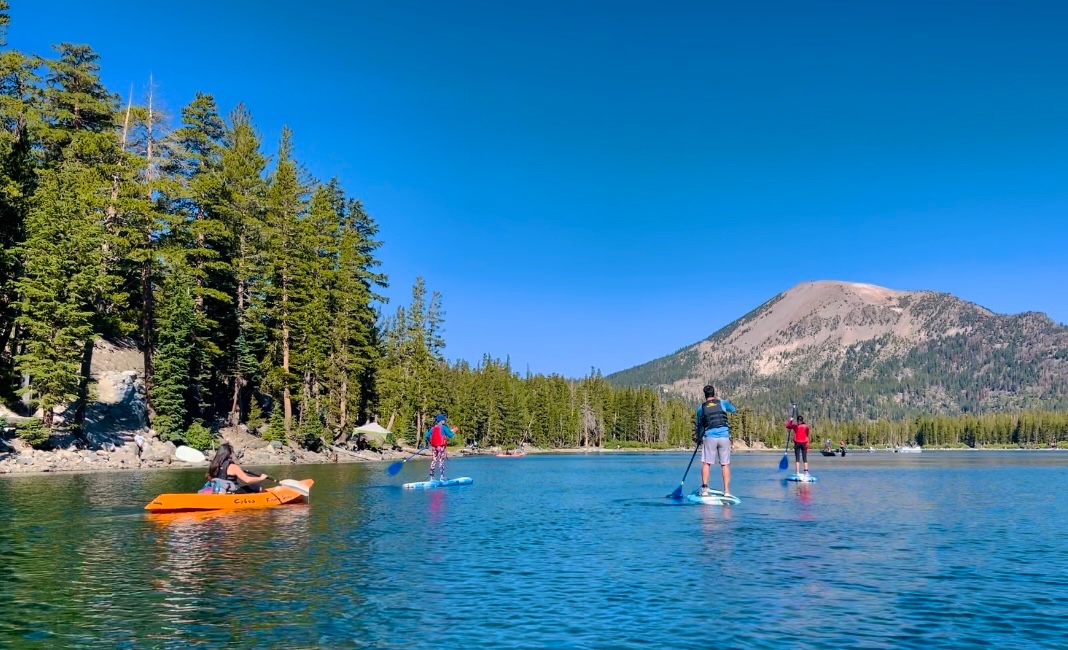 BRENDA & TIGER's family kayaking and stand up paddle boarding in a lake