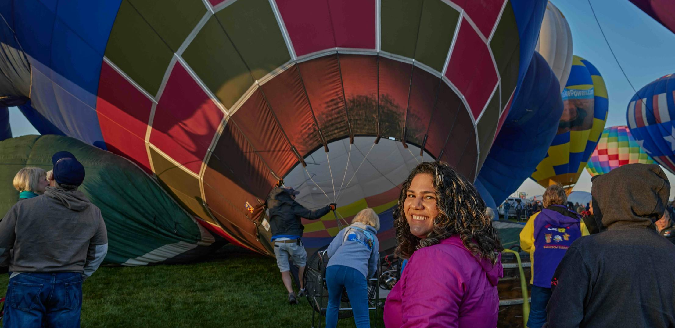 Surna Barton smiling in front of a hot air balloon.