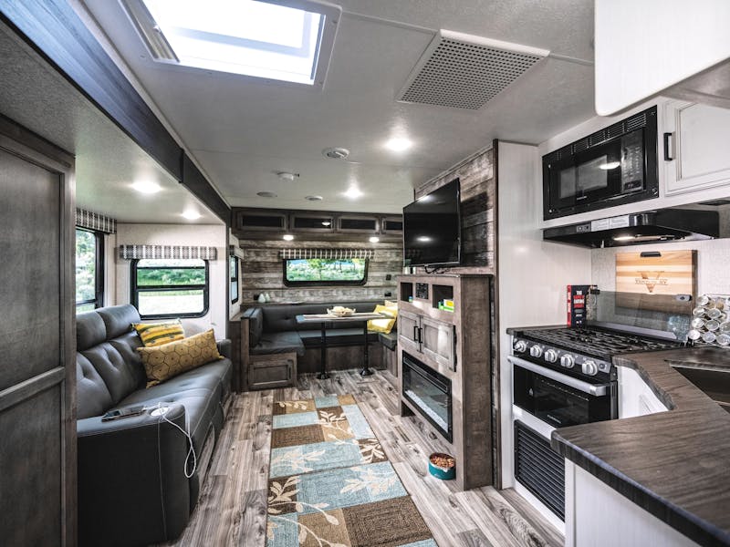 The kitchen and living room interior of a venture stratus rv
