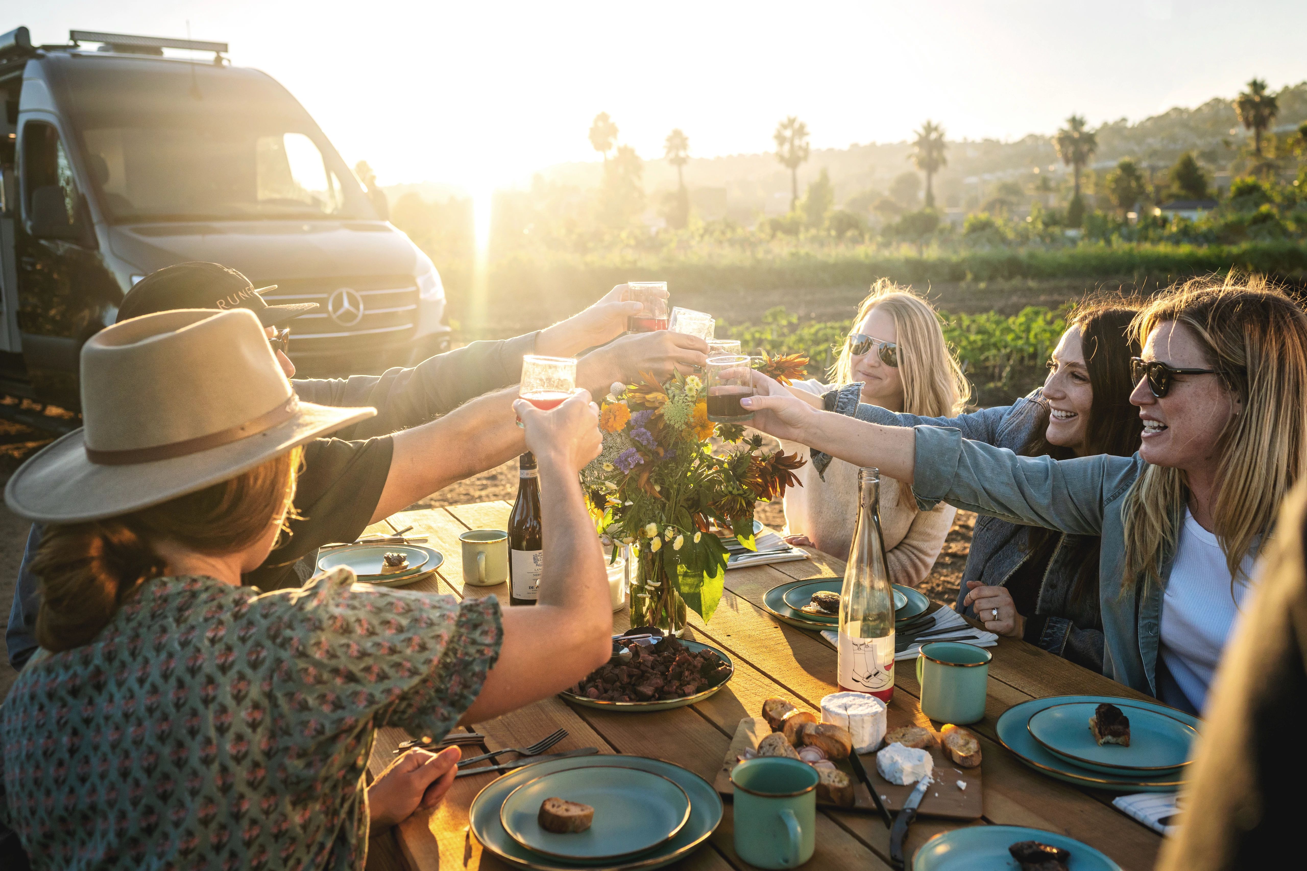 Sarah Glover cheersing a group of friends before eating the meal she made
