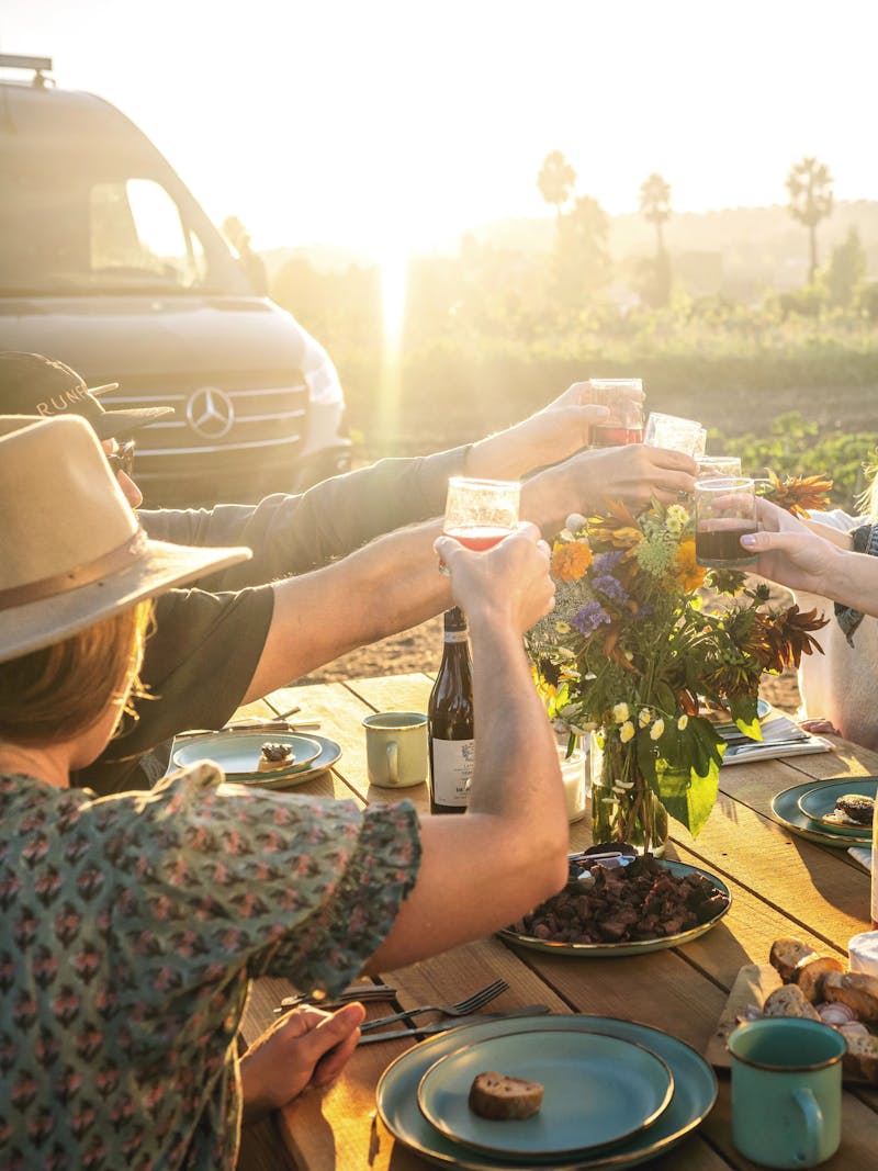 Sarah Glover cheersing a group of friends before eating the meal she made