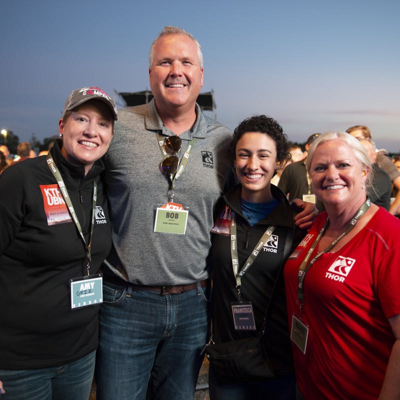 THOR CEO Bob Martin, Renee Jones and participants from First Descents take a photo at THOR's Keith Urban concert. 