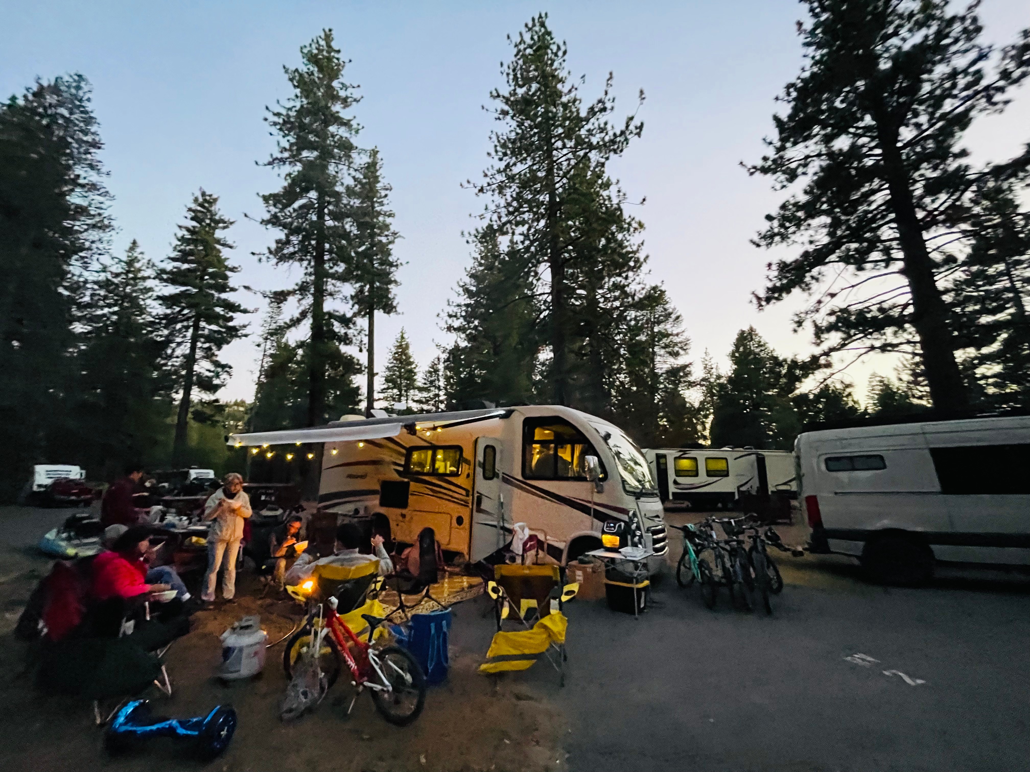 A group of people gathered outside of Brenda and Tiger's Thor Motor Coach Vegas