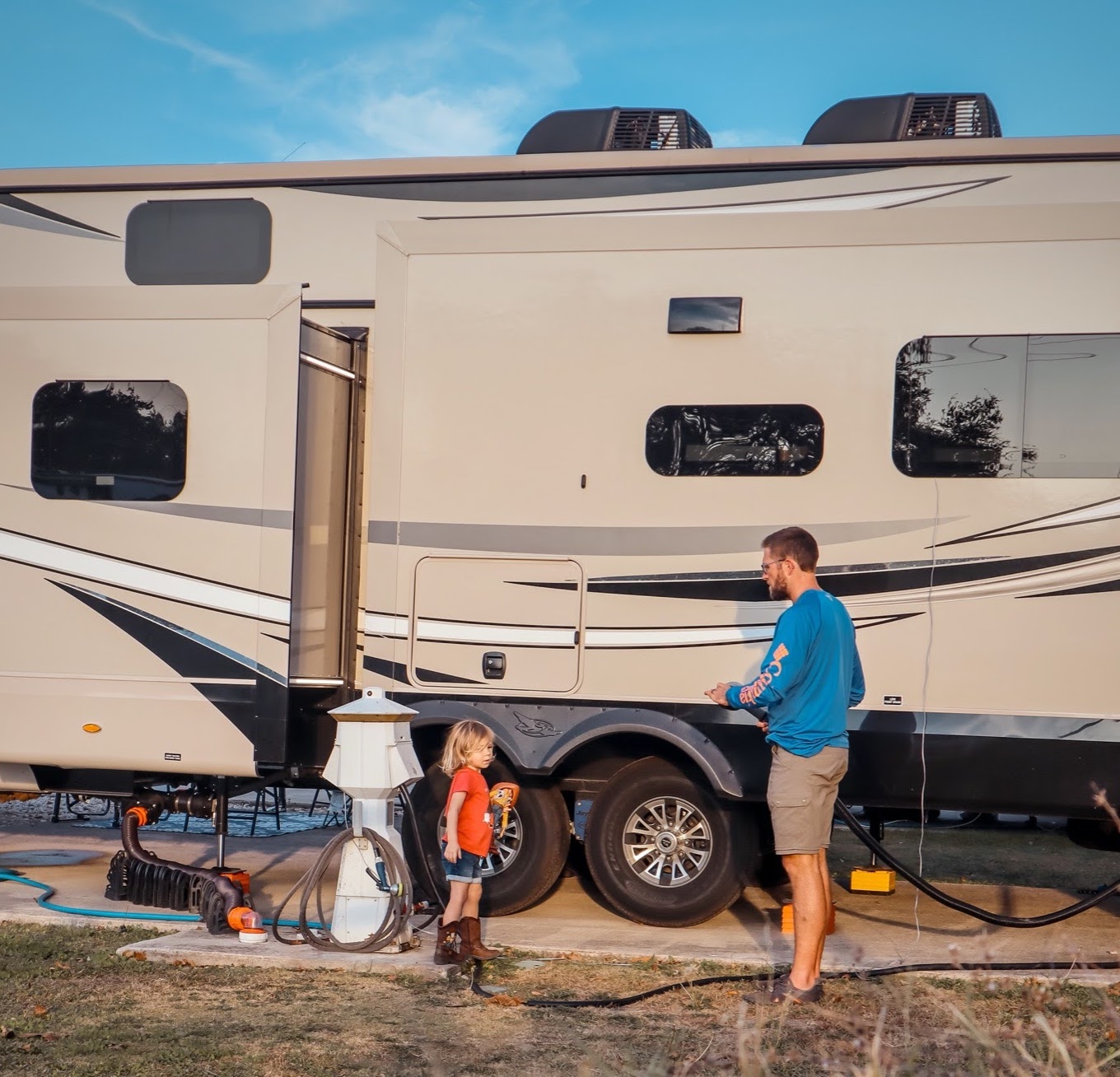 Holly Miner's husband and their son in front of their Jayco Pinnacle.
