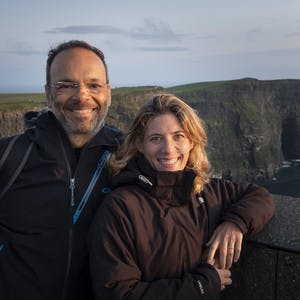 Ariel and Eva Bercovich smile at the camera for a picture while wearing winter jackets on a cloudy day.