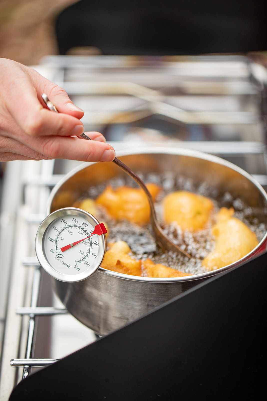 Frying hush puppies in a pot of oil.
