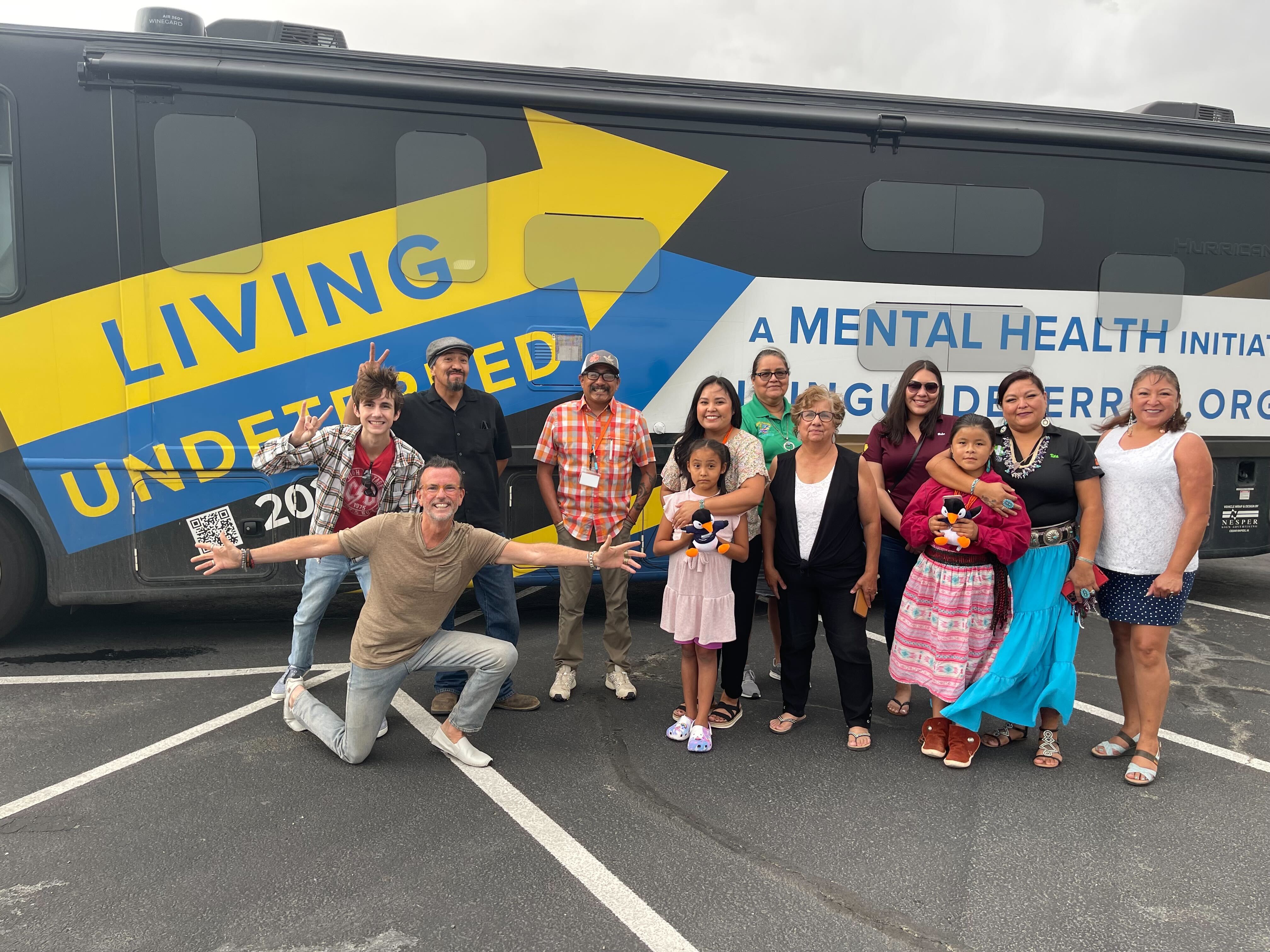 Jeff Johsnton with a large group of people posting in front of his RV