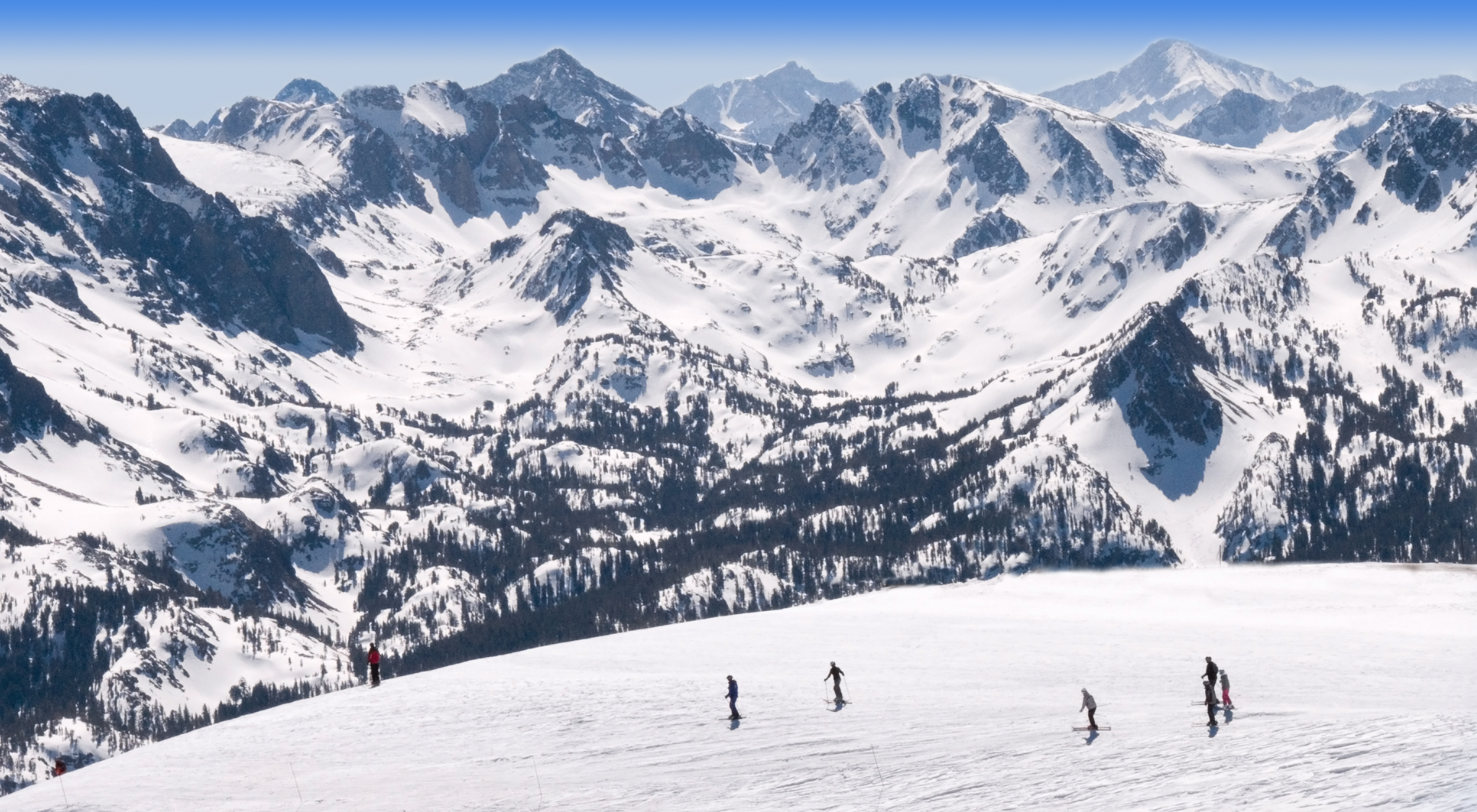 The peaks and valleys of Mammoth Mountain, covered in snow.