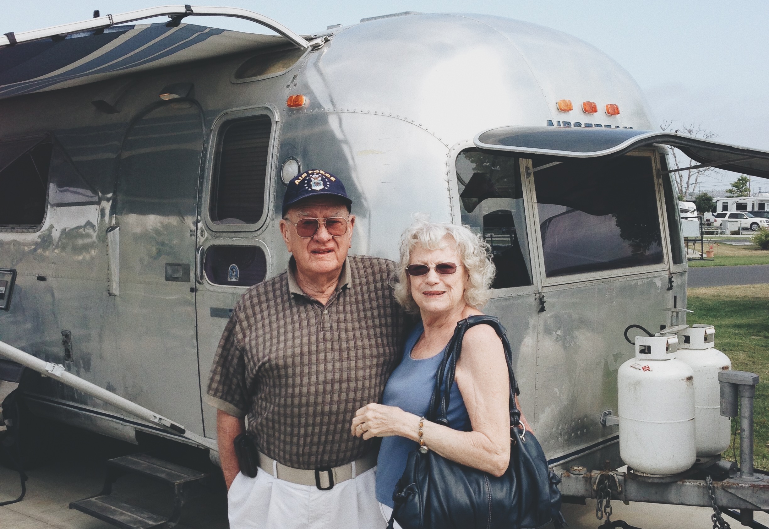 Bill's father and his stepmother, Joyce, standing with the Airstream. 