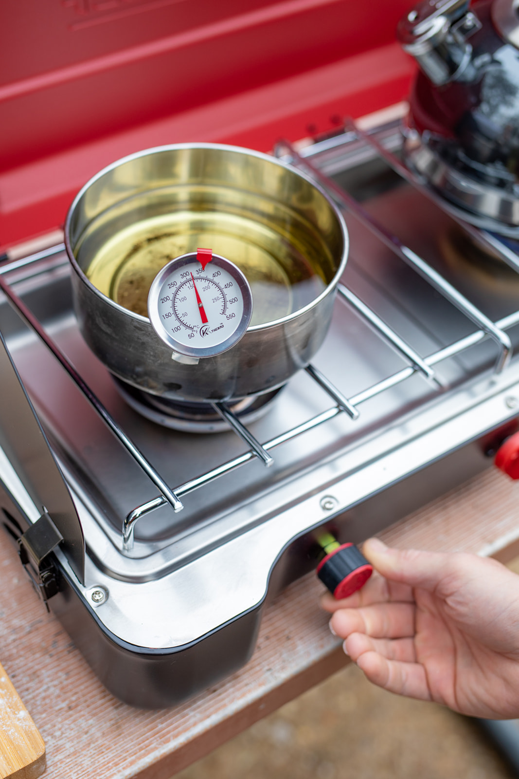 Heating a pot of oil for deep frying on a campsite burner.