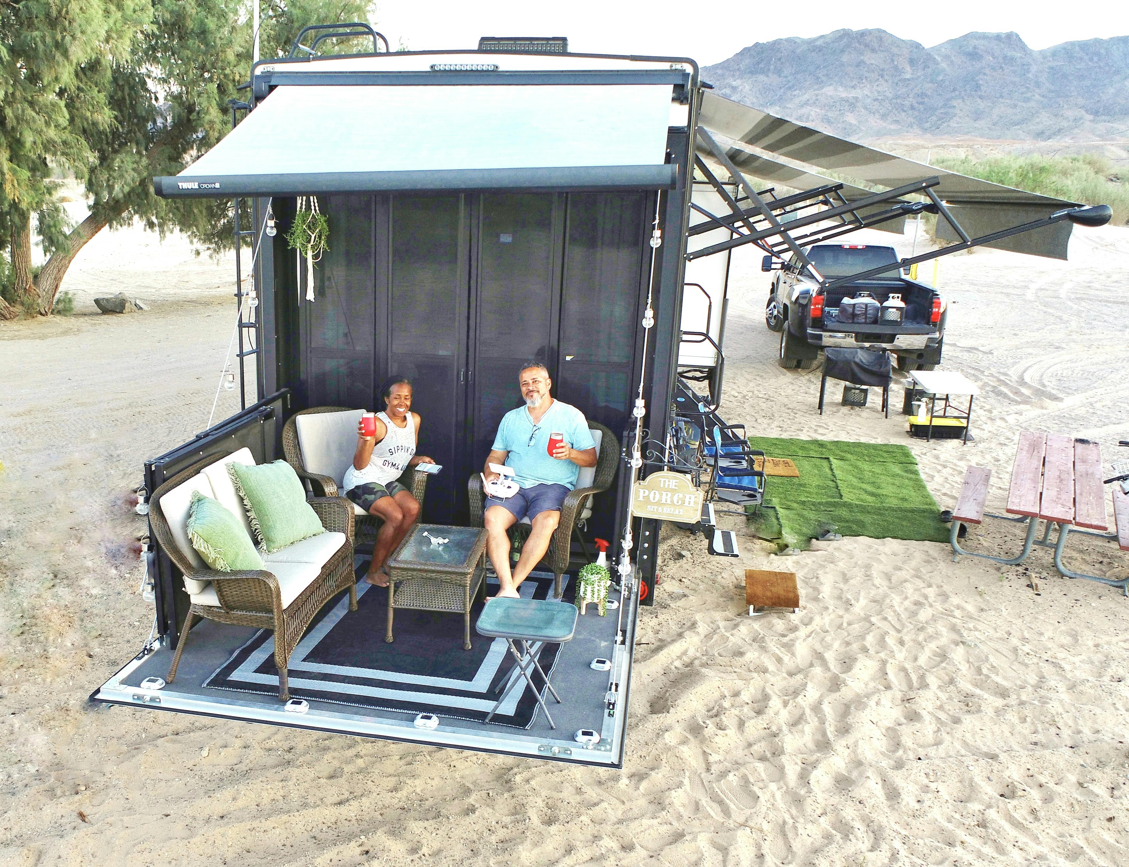 Robin and Warren Baxter relaxing on their porch at their Pirate Cove campsite on the beach