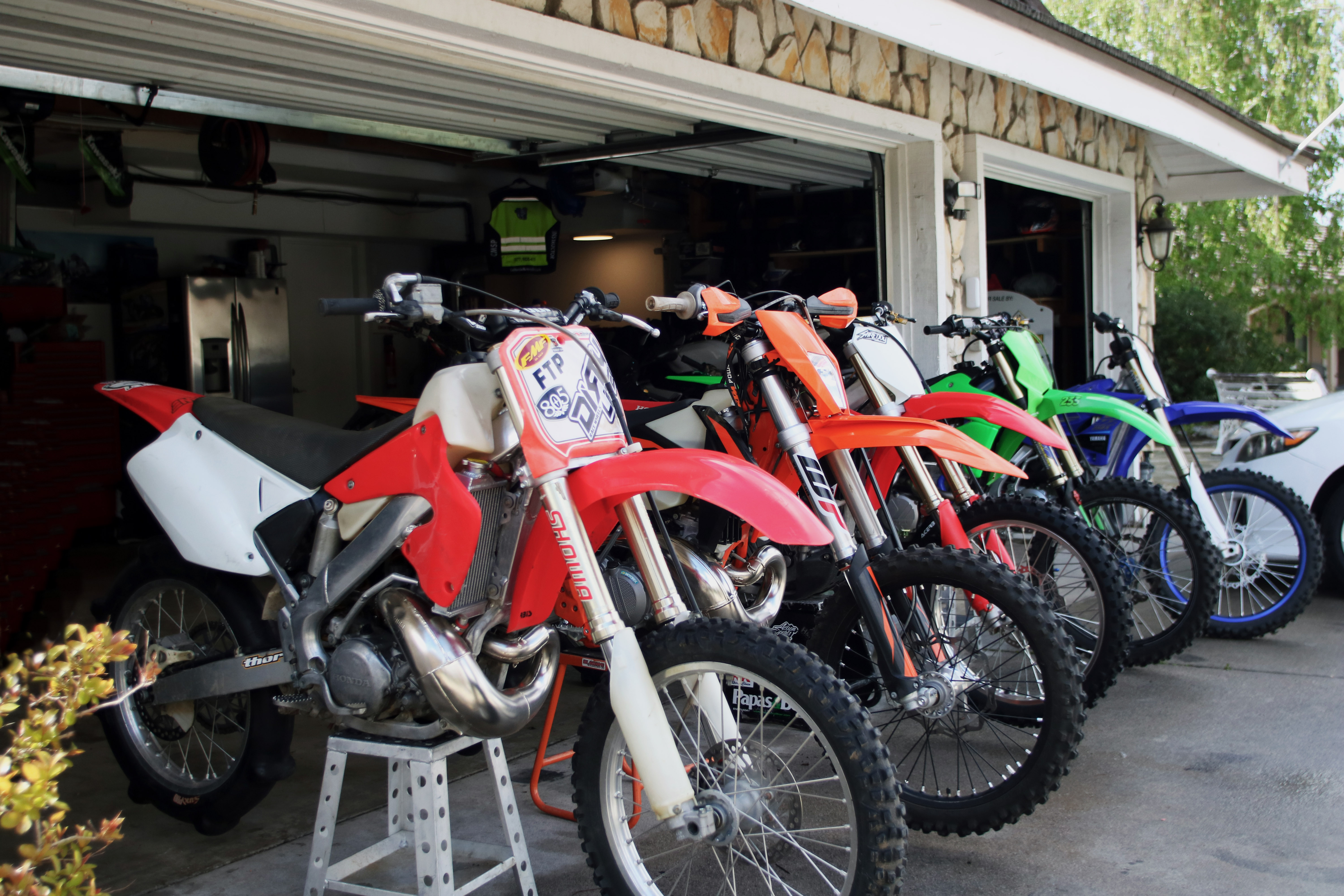Dirt bikes raised up on blocks to tune them up before a trip. 