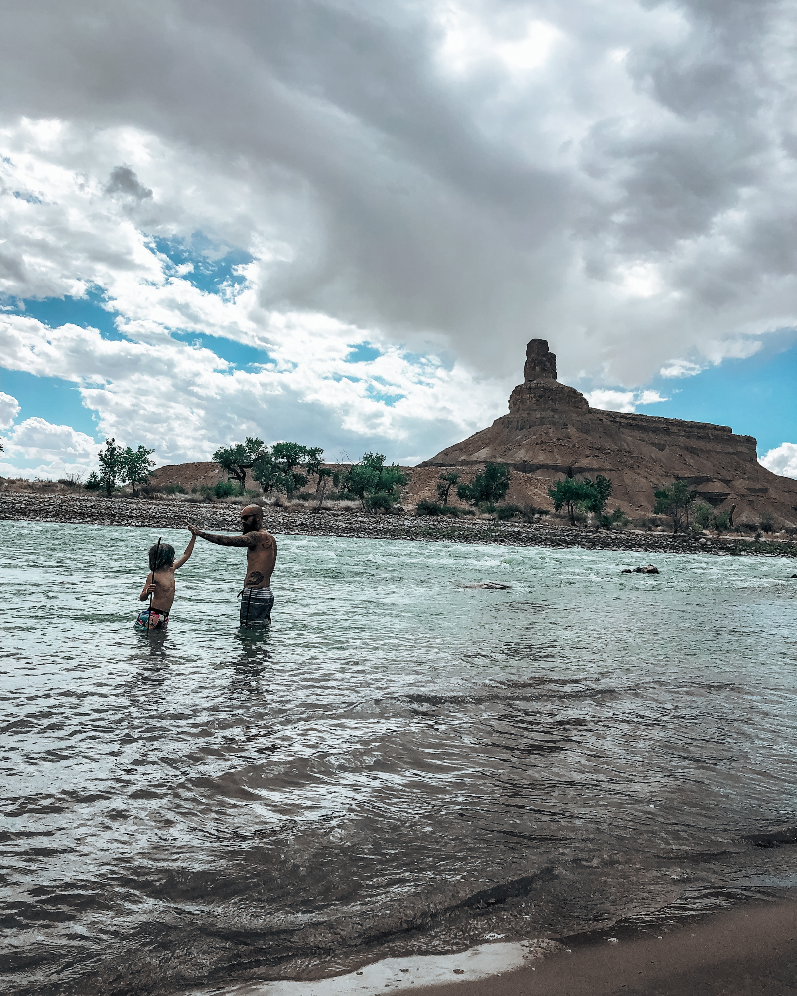 Justin Russell and his son play in a lake. 