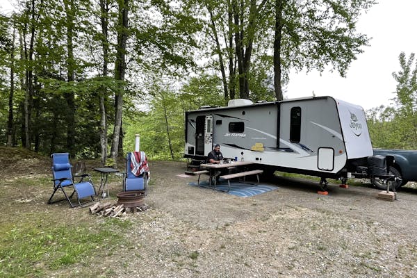 Ben McMillan sitting at a picnic table at their workcamping site