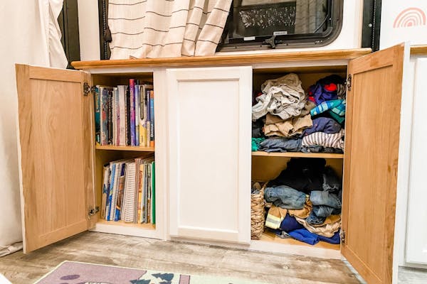 Clothes and school work organized in storage cupboards inside Brittnee Proha's Heartland Cyclone.