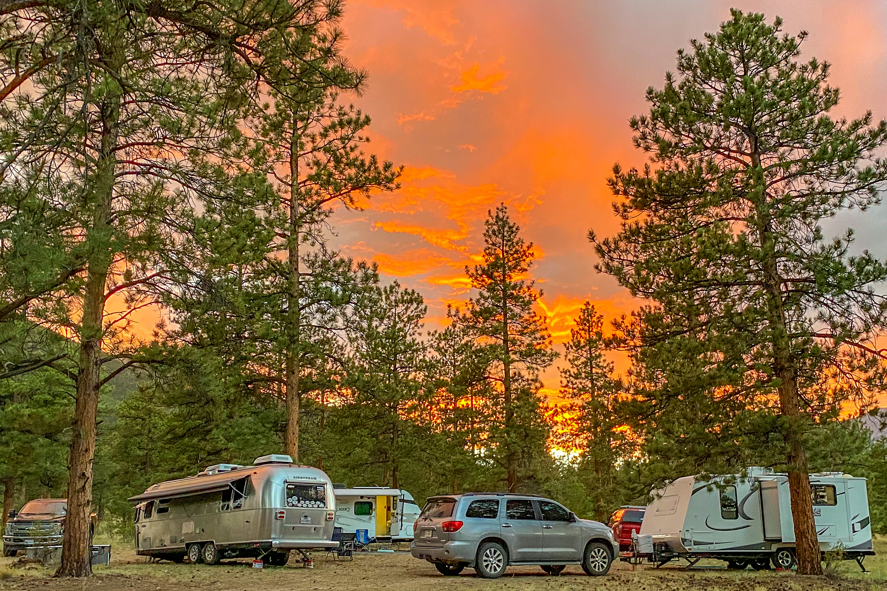 Greg Graham's Airstream and multiple RVs parked in a circle under an orange sky.