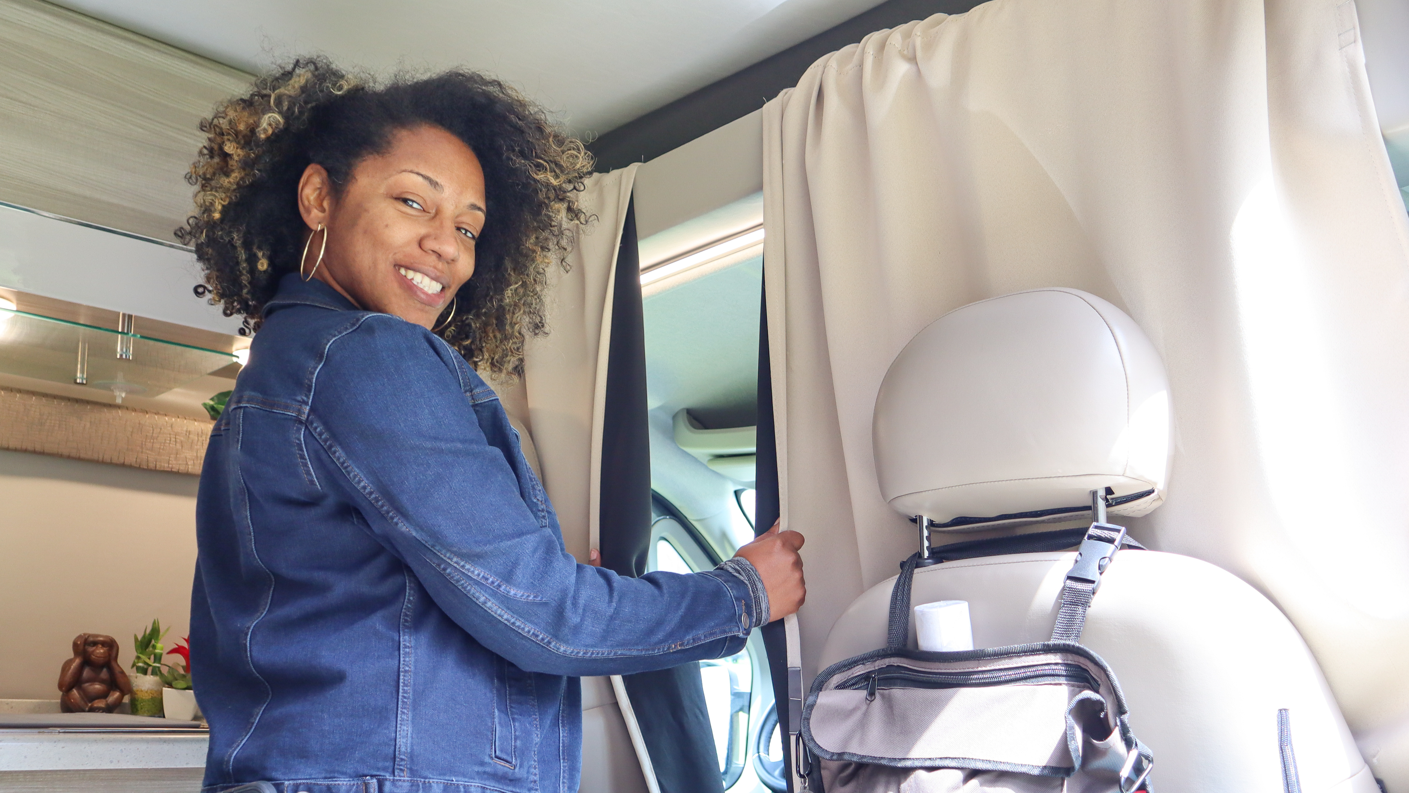 Rocio shutting a curtain inside of her RV