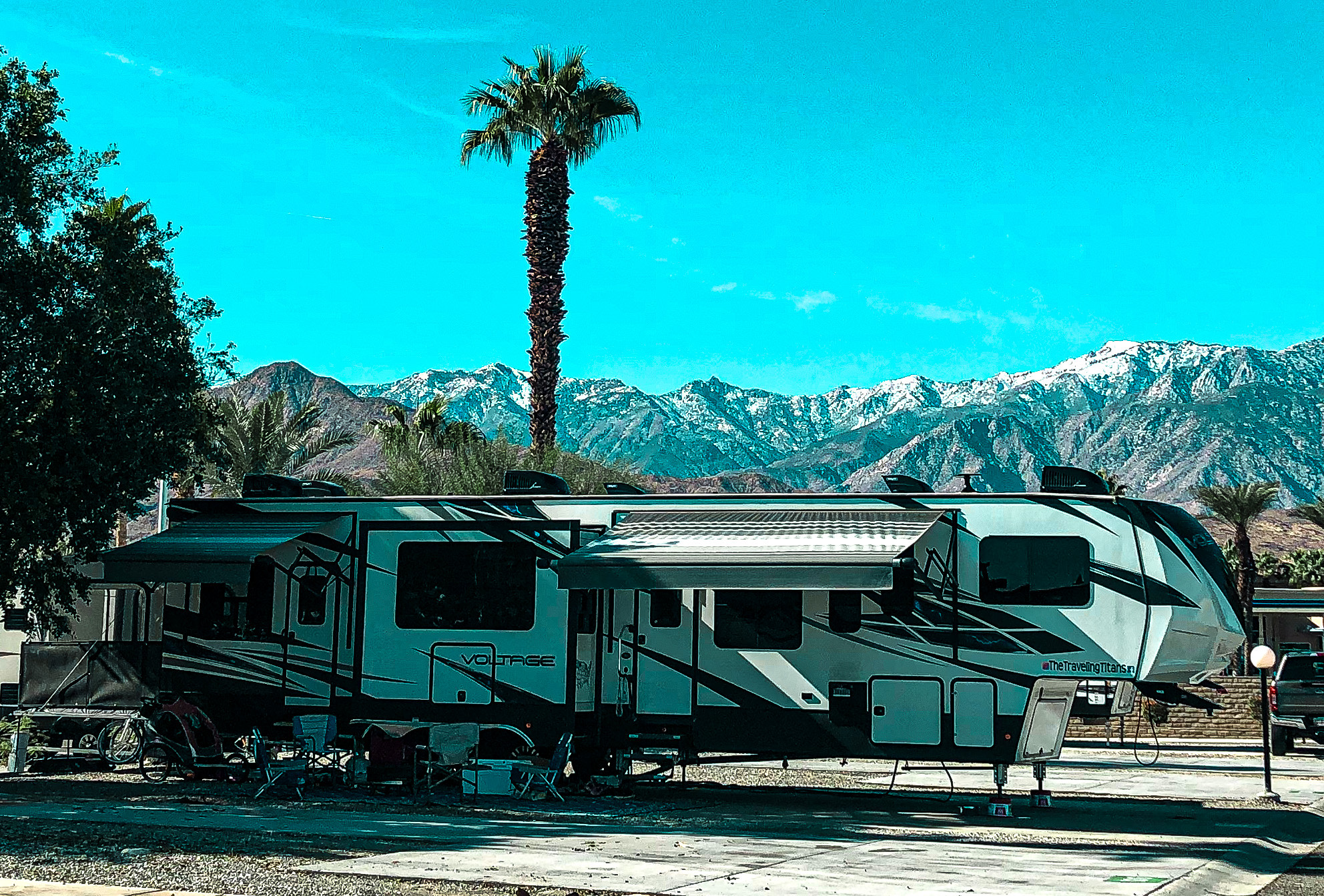 SAMANTHA BADERSCHNEIDER AND BLAKE EDMUNDS RV parked at a capmground with mountains in the background
