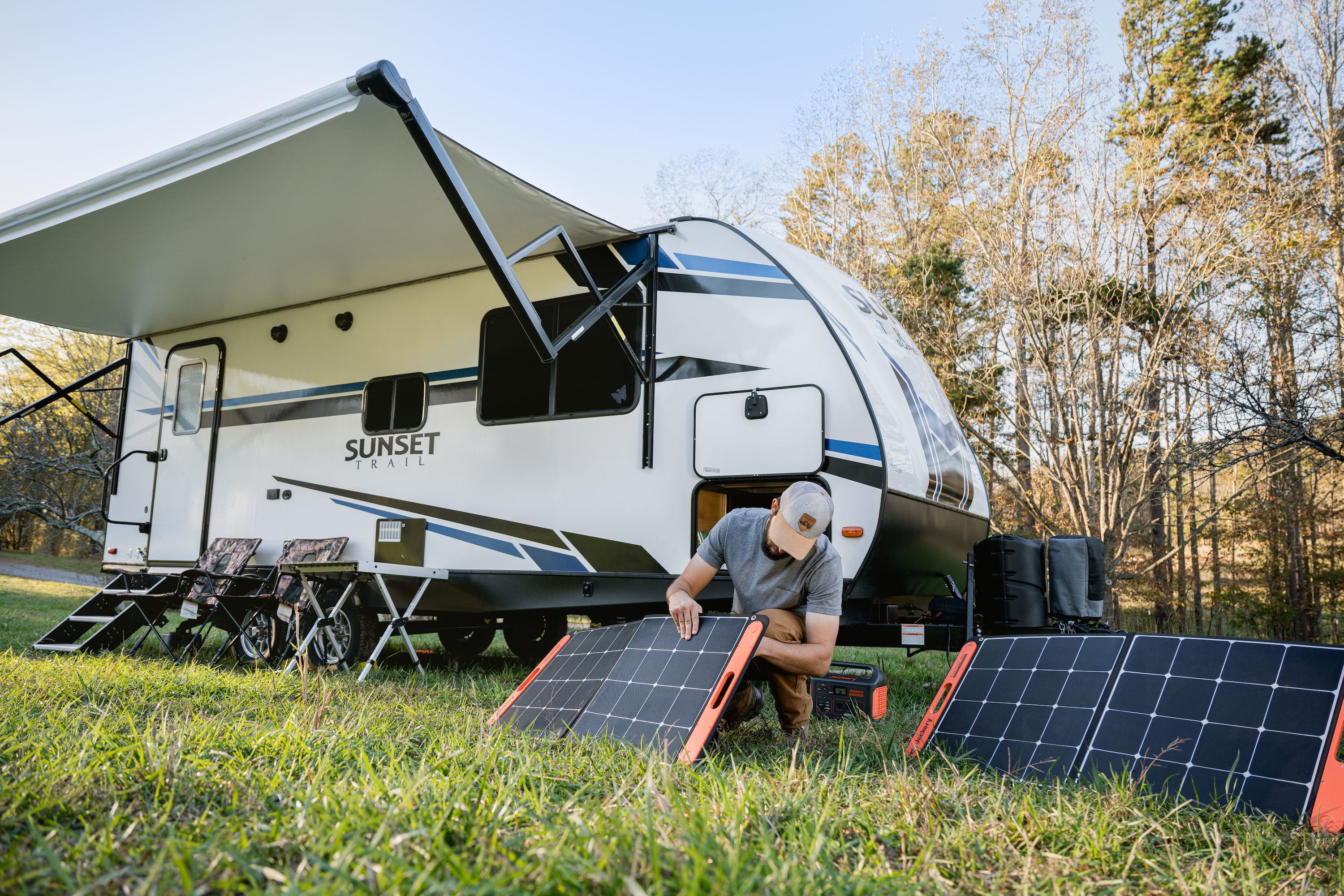 Todd Schabel sets up solar panels to power his Sunset Trail travel trailer. 